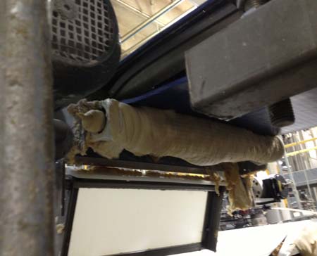 Beef scraps on the ground underneath the conveyor