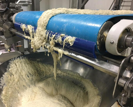 Beef scraps on the ground underneath the conveyor